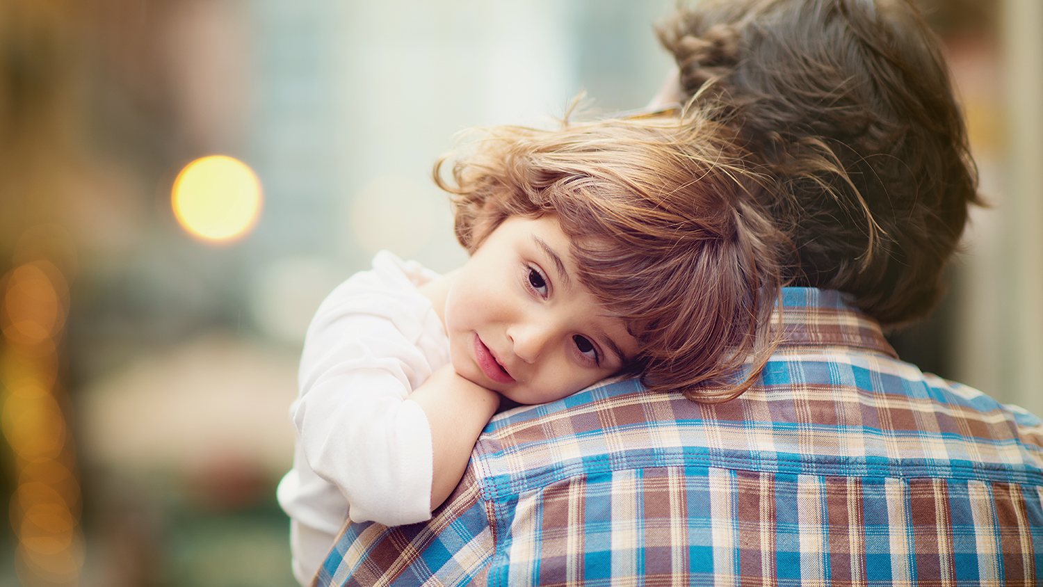 A father holding his young daughter, representing the child advocacy work of Lisa Kane Brown, a lawyer in Norristown, PA, specializing in abuse cases, adoption assistance, and child abuse civil litigation in Montgomery County, Pennsylvania.