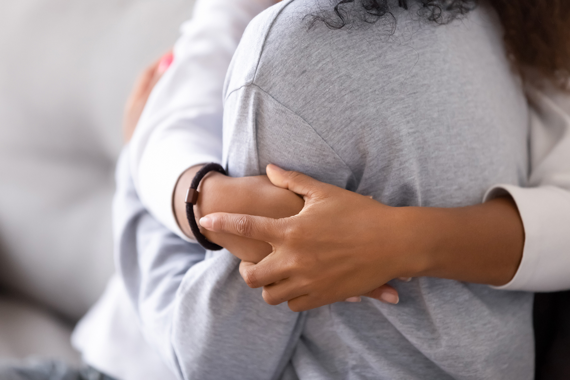 A comforting embrace symbolizing support for a neglected child, highlighting the signs of child neglect.